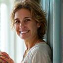 A bright-eyed, energetic woman in her early 40s, looking refreshed and vibrant.